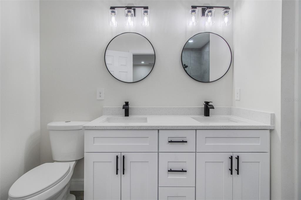 406 Ruby Avenue Deland, FL 32724 - Photo 10 of 23 a bathroom with a toilet a sink and a mirror