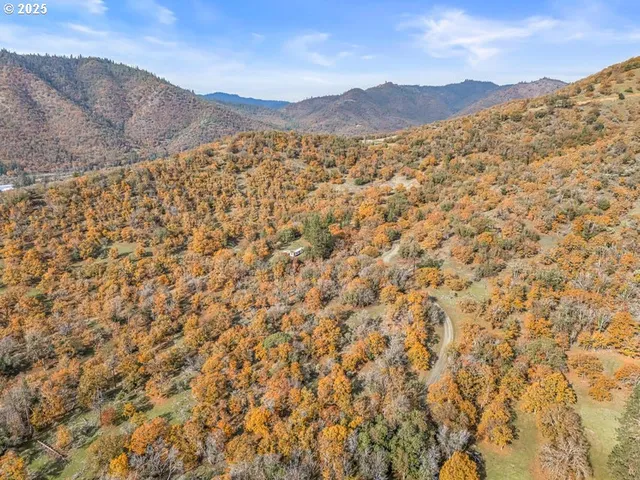 a view of a large mountain with mountains in the background