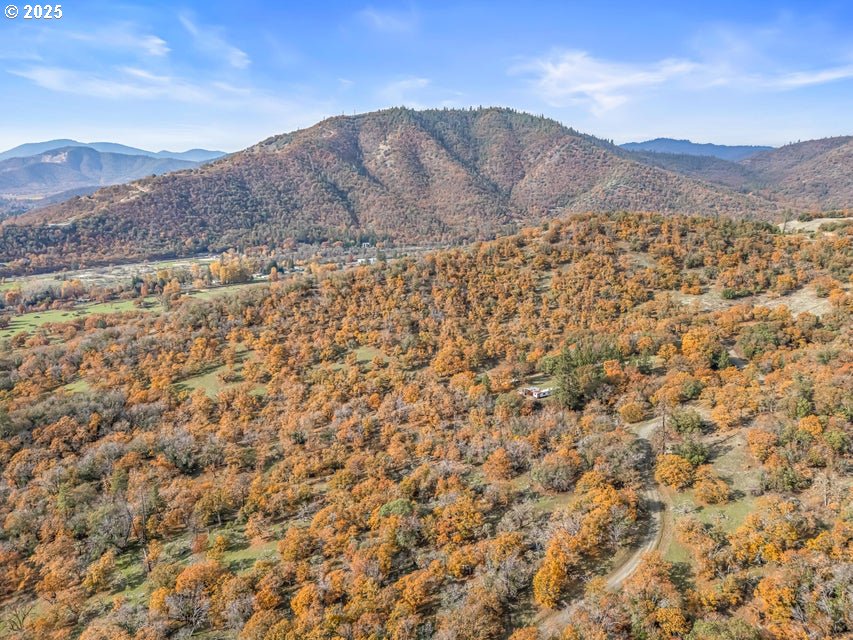 11926 Blackwell Road Central Point, OR 97502 - Photo 8 of 18 a view of a dry yard with mountains in the background