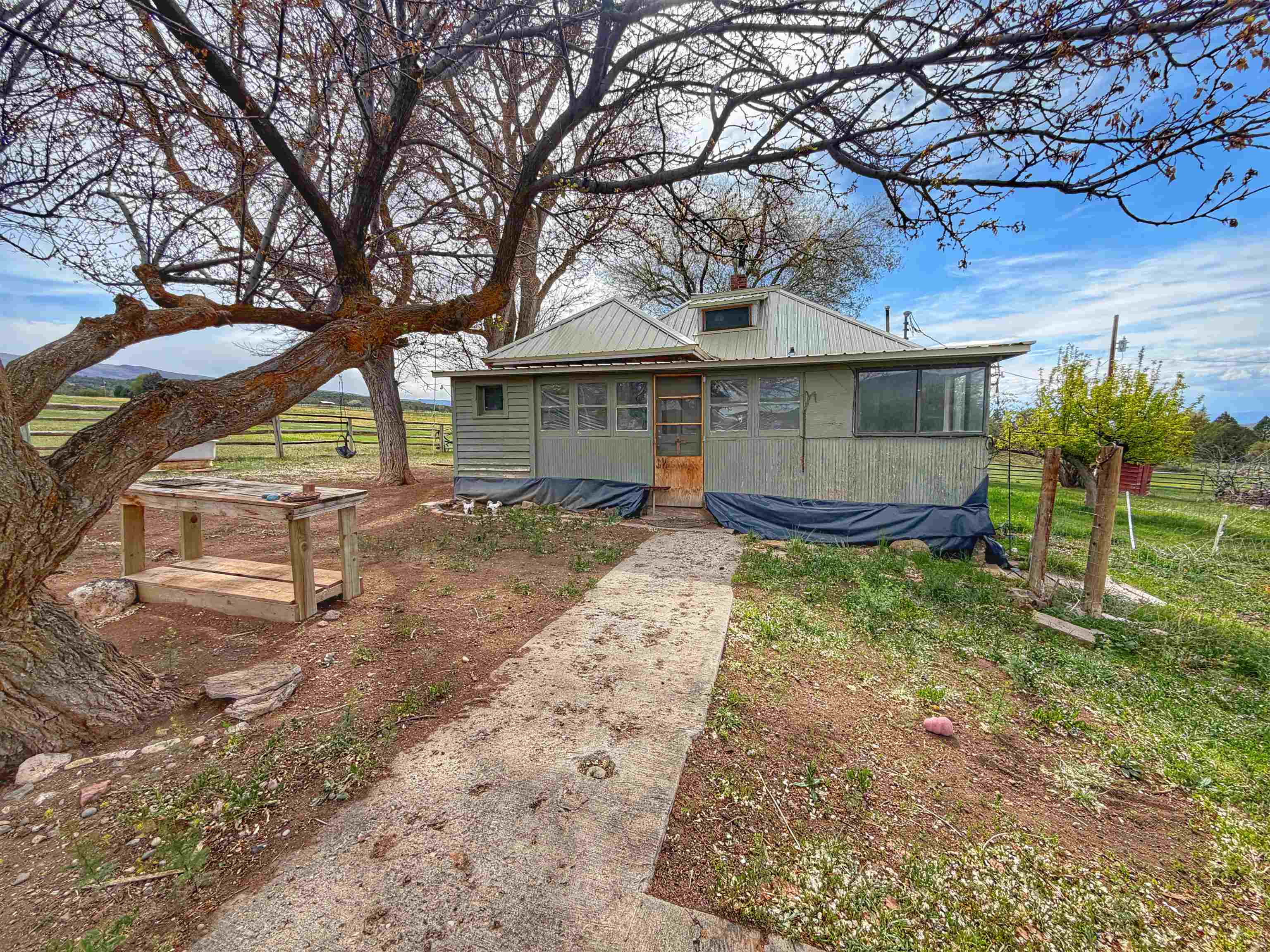 11260 54 7/10 Road Molina, CO 81646 - Photo 5 of 31 a backyard of a house with wooden fence and large trees