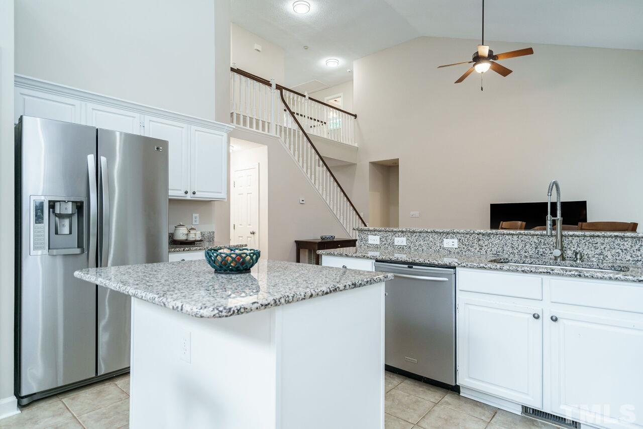 206 Firetree Lane Cary, NC 27513 - Photo 13 of 44 a kitchen with granite countertop a sink a counter top space appliances and cabinets