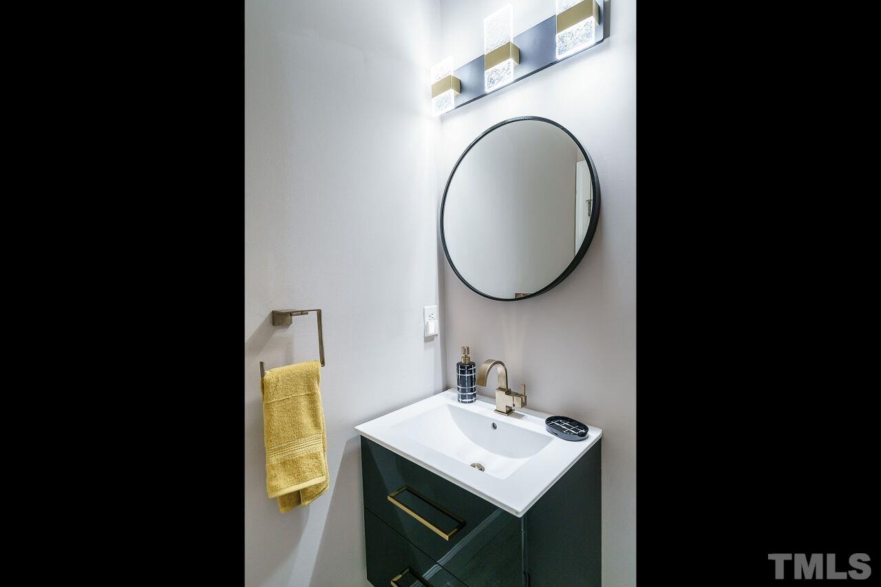 206 Firetree Lane Cary, NC 27513 - Photo 15 of 44 a bathroom with a sink and a mirror