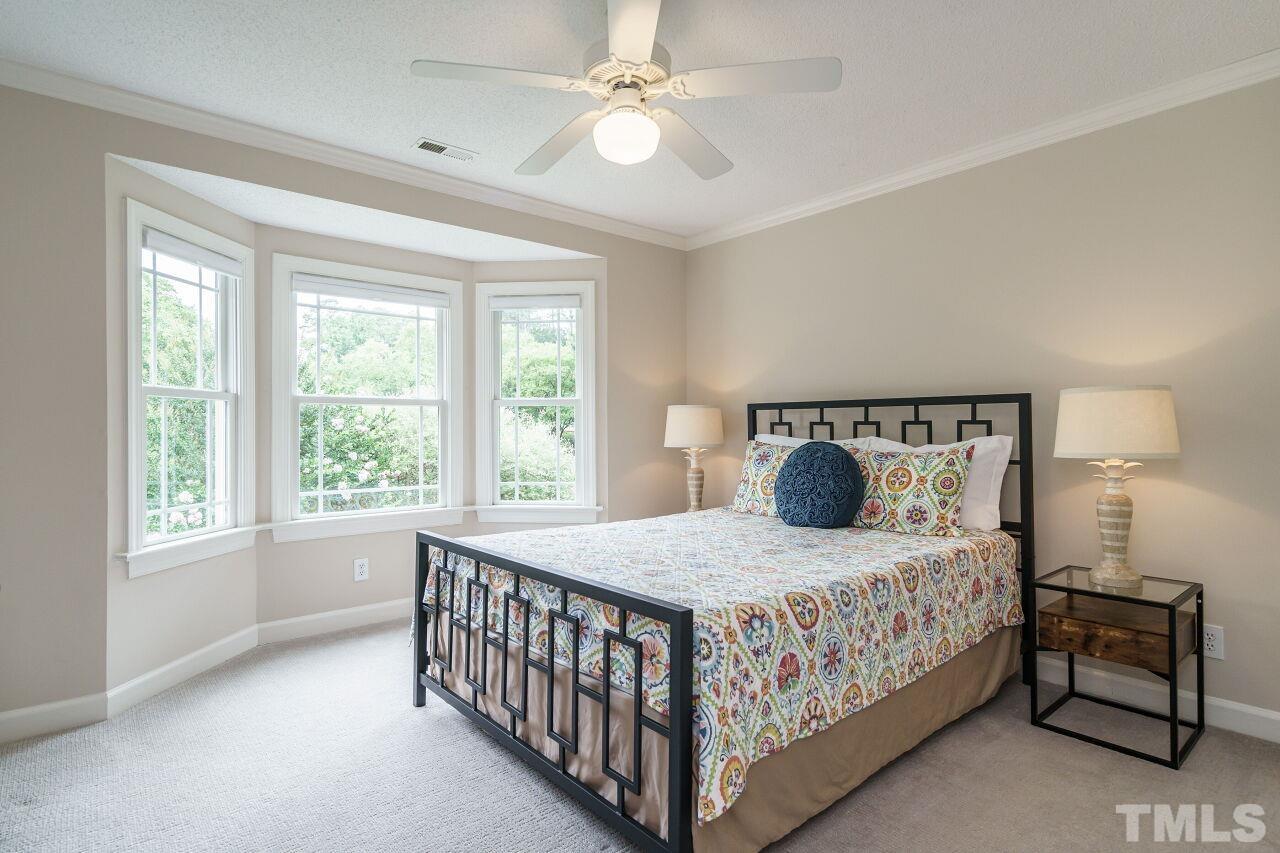 206 Firetree Lane Cary, NC 27513 - Photo 20 of 44 a bedroom with a bed and a window