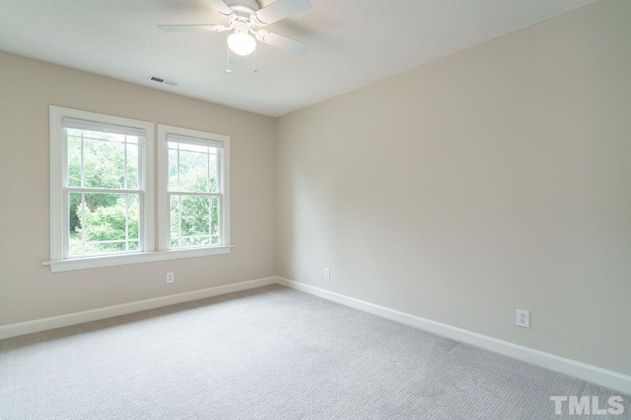 206 Firetree Lane Cary, NC 27513 - Photo 23 of 44 an empty room with a window and a fan