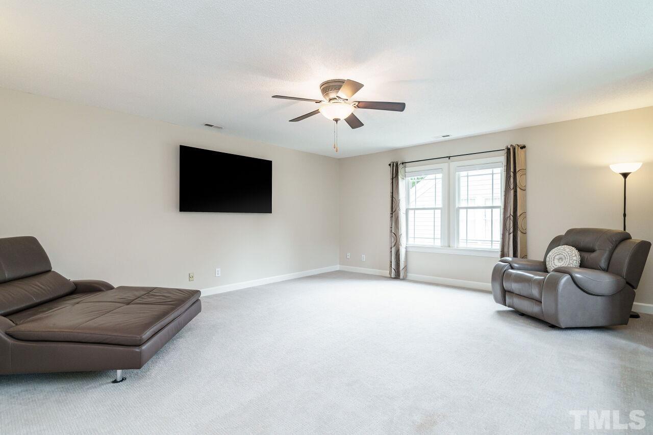 206 Firetree Lane Cary, NC 27513 - Photo 24 of 44 a living room with furniture and a flat screen tv