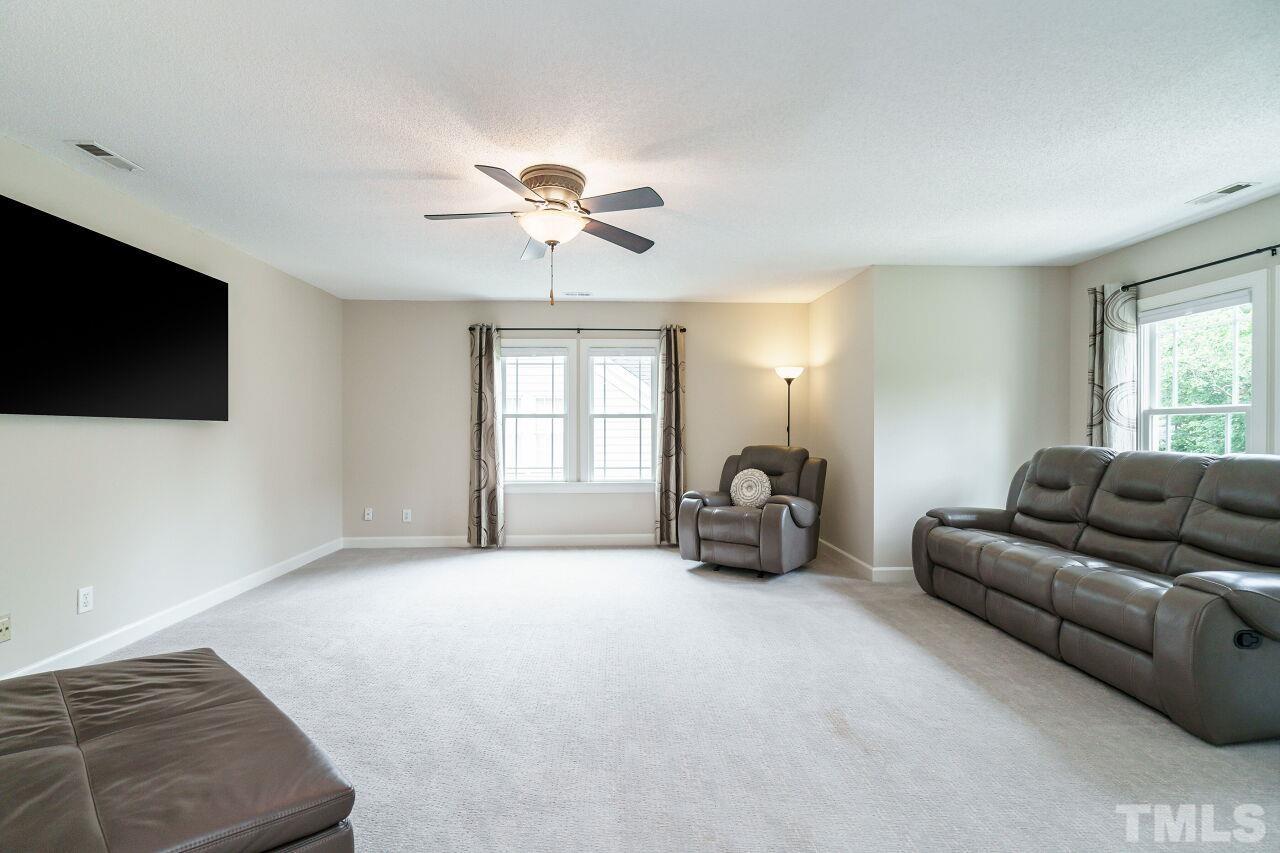 206 Firetree Lane Cary, NC 27513 - Photo 26 of 44 a living room with furniture and a flat screen tv