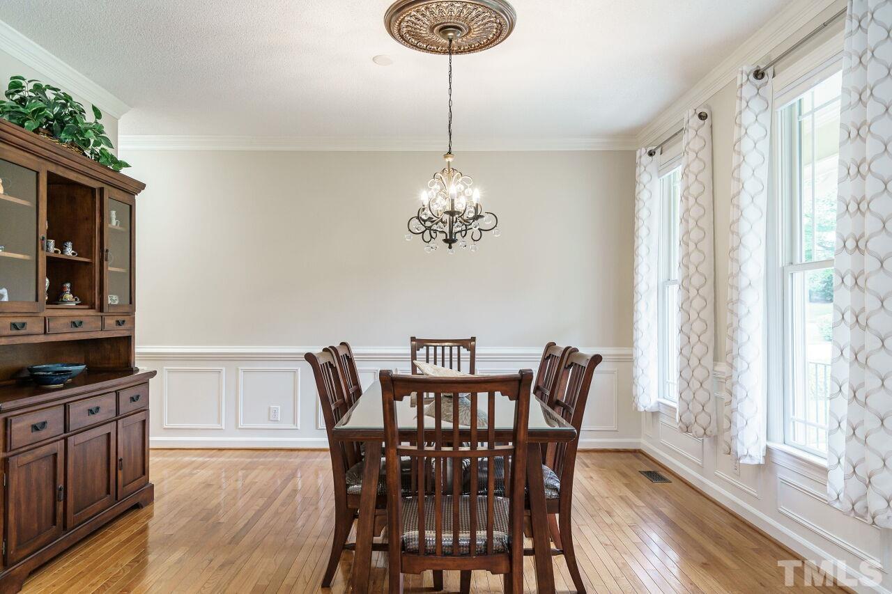 206 Firetree Lane Cary, NC 27513 - Photo 4 of 44 a view of a dining room with furniture window and wooden floor