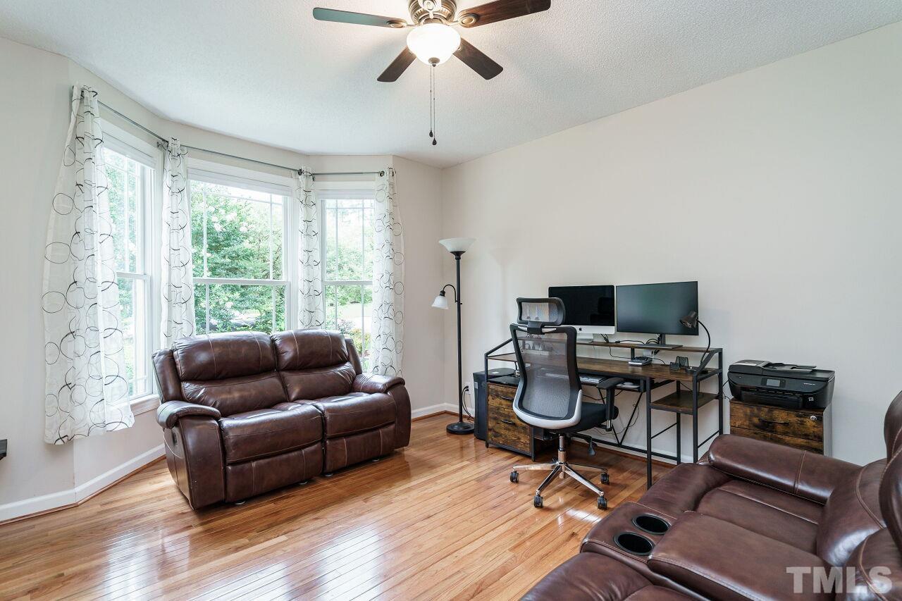206 Firetree Lane Cary, NC 27513 - Photo 5 of 44 a living room with furniture and a flat screen tv