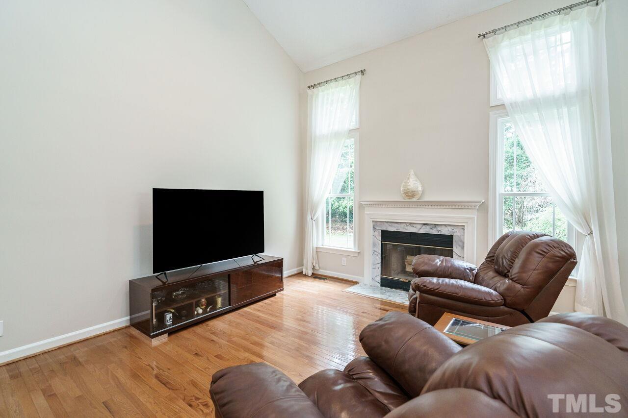 206 Firetree Lane Cary, NC 27513 - Photo 6 of 44 a living room with furniture and a flat screen tv