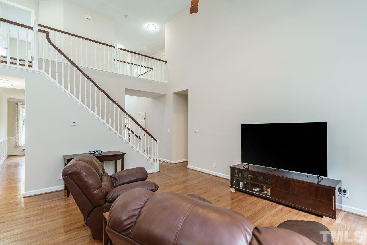 206 Firetree Lane Cary, NC 27513 - Photo 8 of 44 a living room with furniture and a flat screen tv