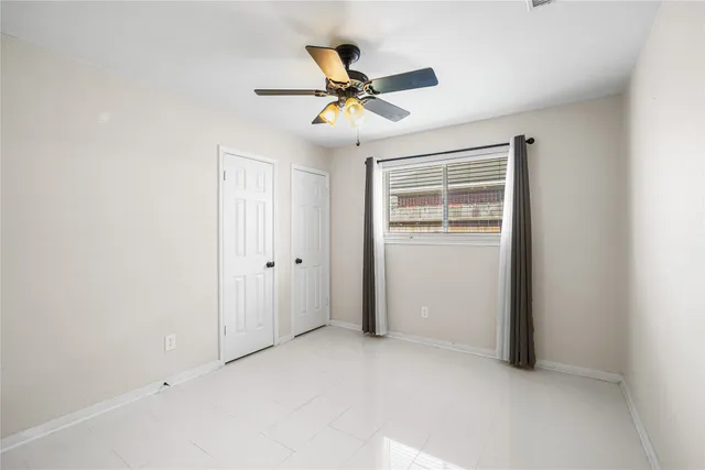 a view of a livingroom with a ceiling fan and wooden floor