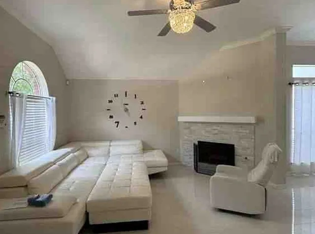 a living room with furniture and a fireplace