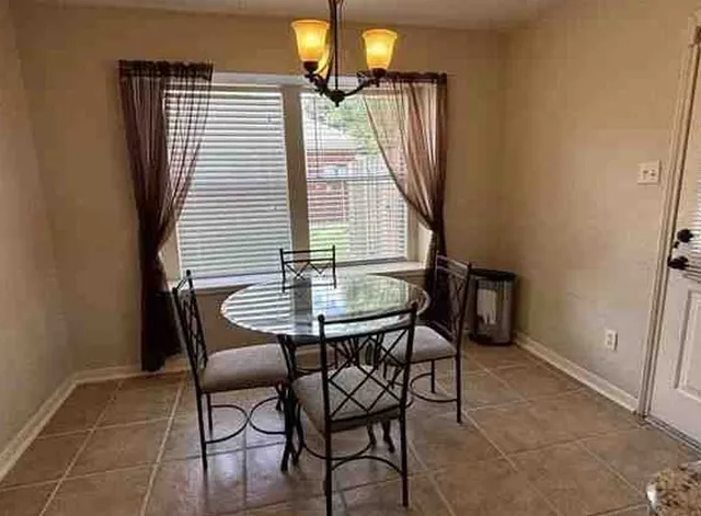 a view of a dining room with furniture and window