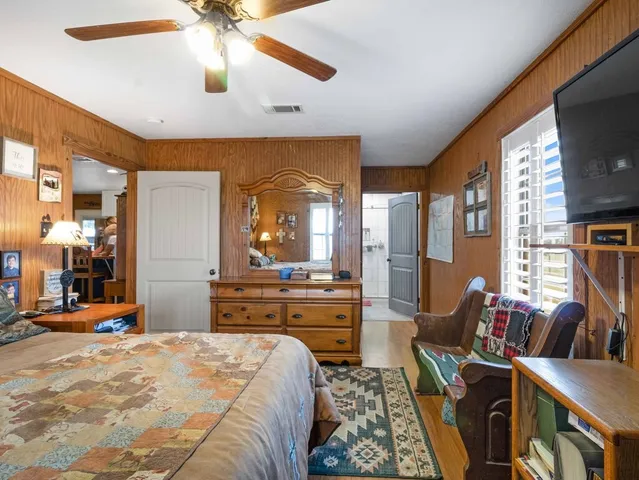 a bed room with furniture and a flat screen tv