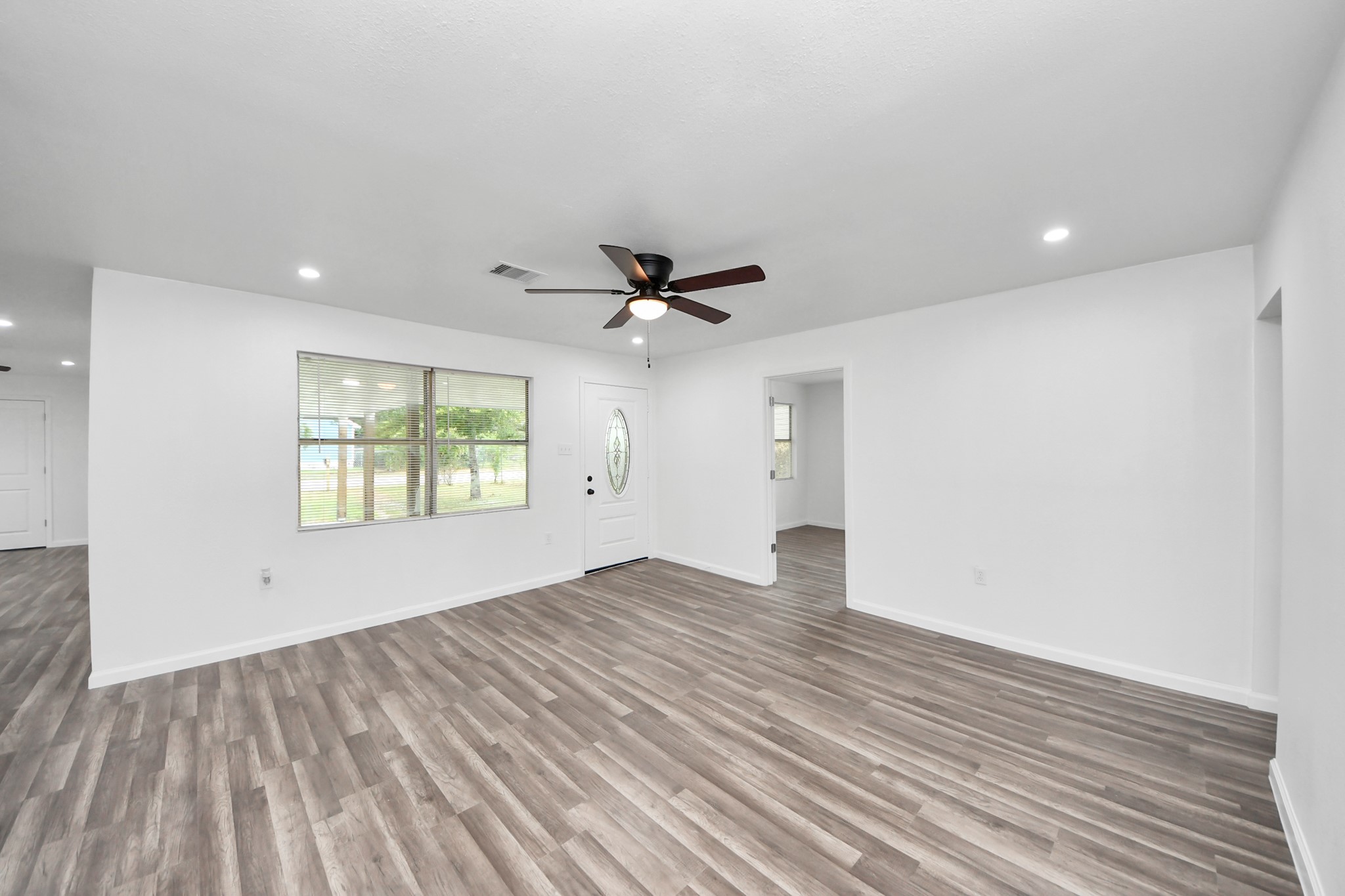 207 East Defee Avenue Baytown, TX 77520 - Photo 11 of 36 wooden floor in an empty room with a window