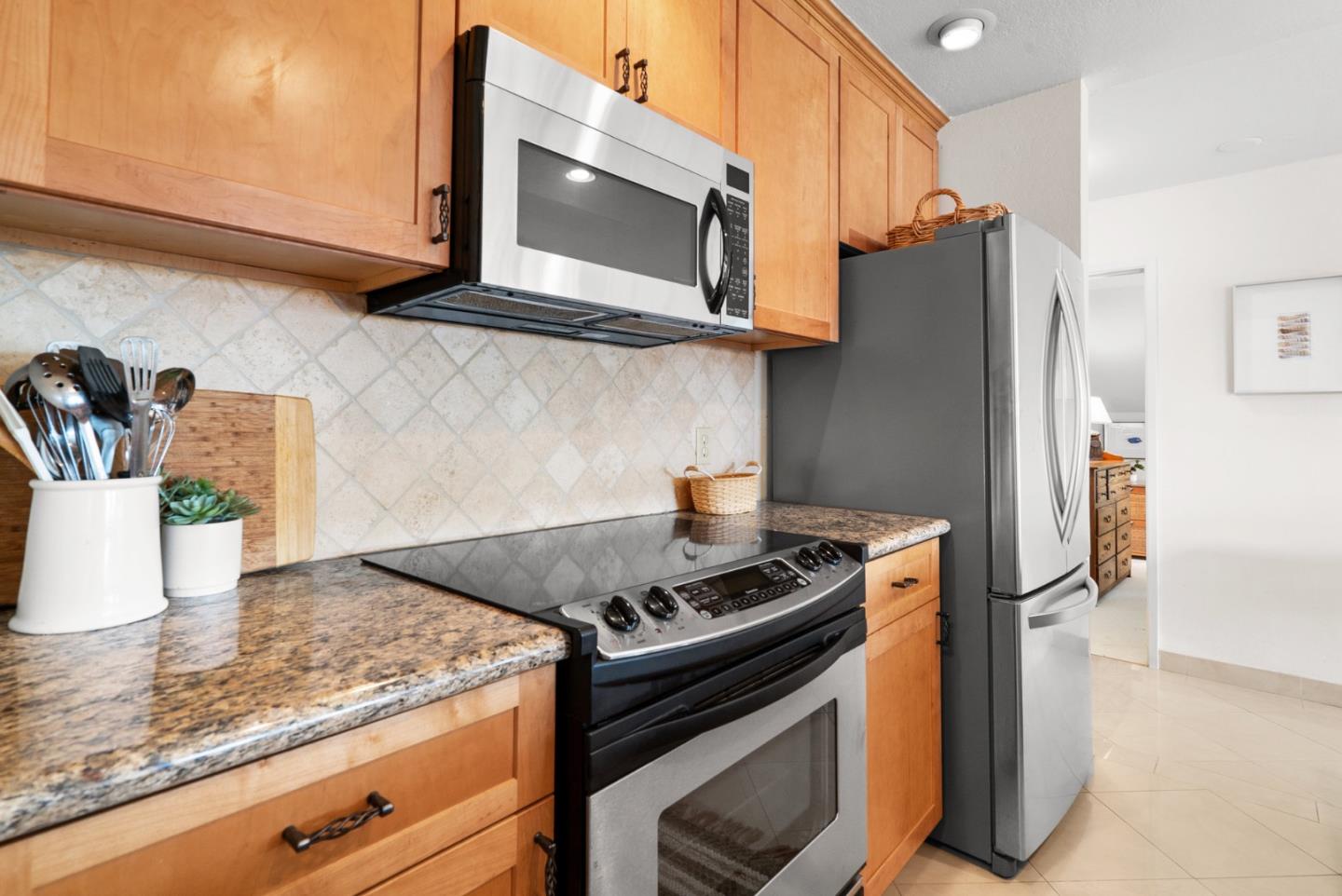 101 Shell Road, Unit 127 Watsonville, CA 95076 - Photo 22 of 54 a kitchen with stainless steel appliances granite countertop a stove a refrigerator and a microwave