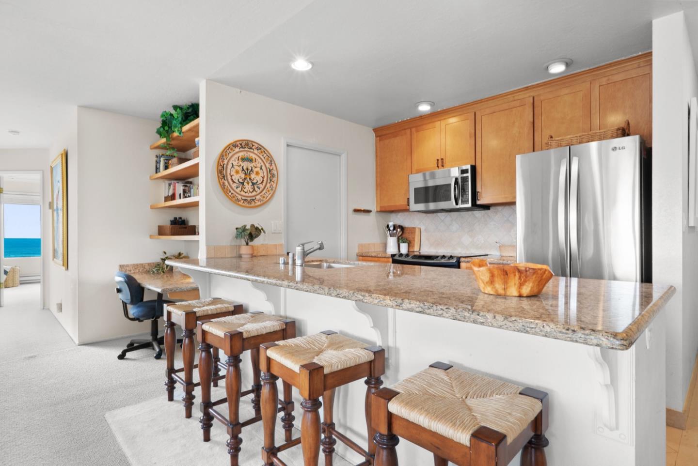 101 Shell Road, Unit 127 Watsonville, CA 95076 - Photo 32 of 54 a kitchen with stainless steel appliances granite countertop a sink and a refrigerator