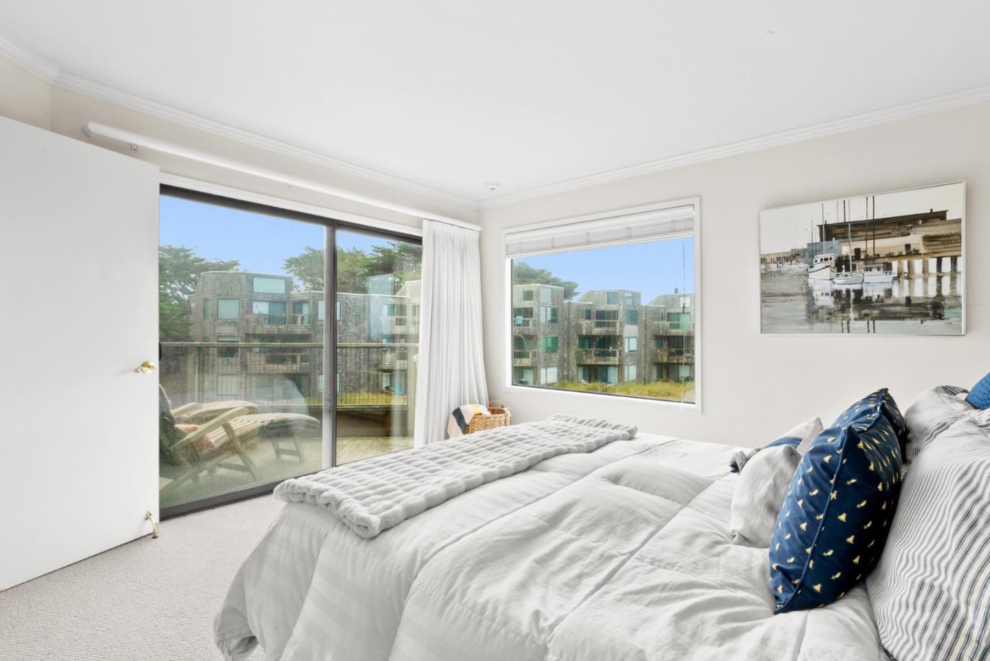 101 Shell Road, Unit 127 Watsonville, CA 95076 - Photo 37 of 54 a bedroom with a large bed and a large window