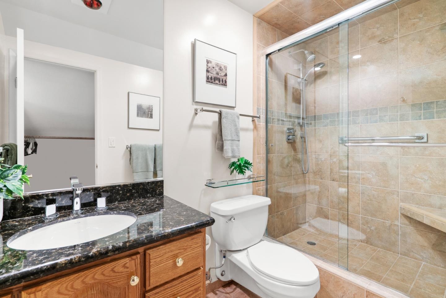 101 Shell Road, Unit 127 Watsonville, CA 95076 - Photo 45 of 54 a bathroom with a granite countertop toilet a sink and a mirror