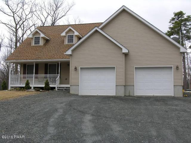 215 Maple Ridge Drive Hawley, PA 18428 - Photo 2 of 14 a front view of a house with a yard and garage