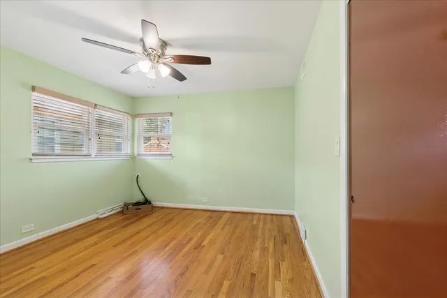 a view of a room with wooden floor closet and windows
