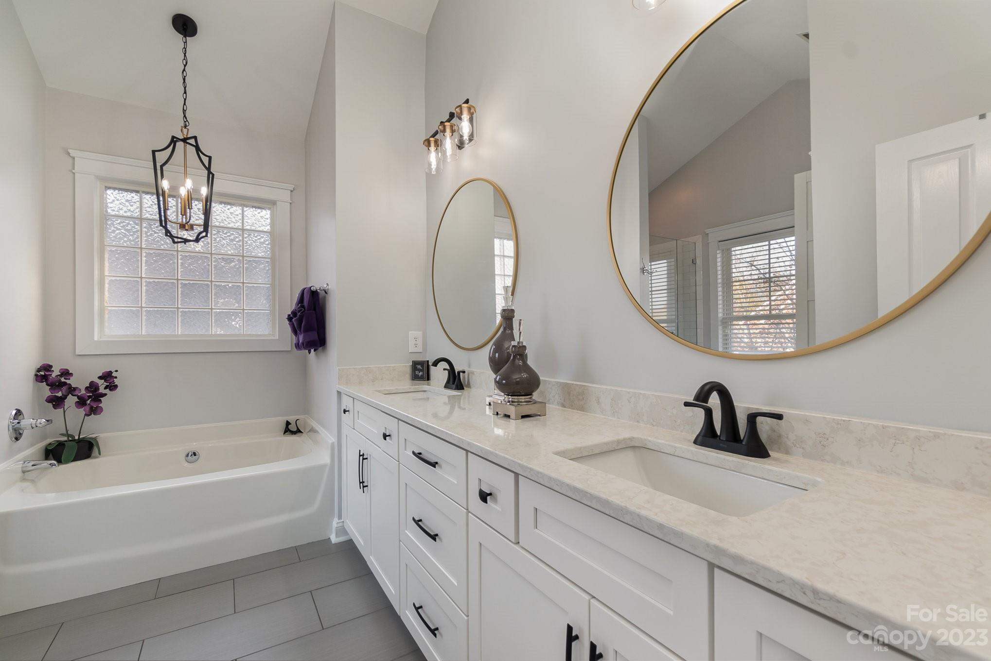8128 Townley Road Huntersville, NC 28078 - Photo 13 of 20 a bathroom with a tub sink and mirror