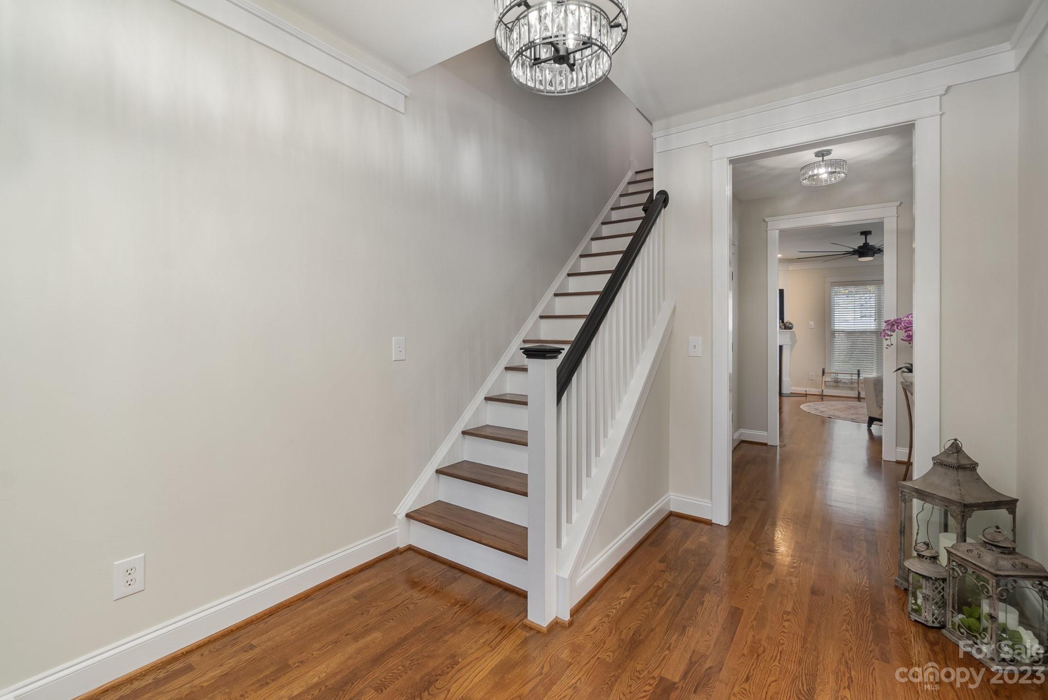 8128 Townley Road Huntersville, NC 28078 - Photo 3 of 20 a view of a hallway with wooden floor and staircase