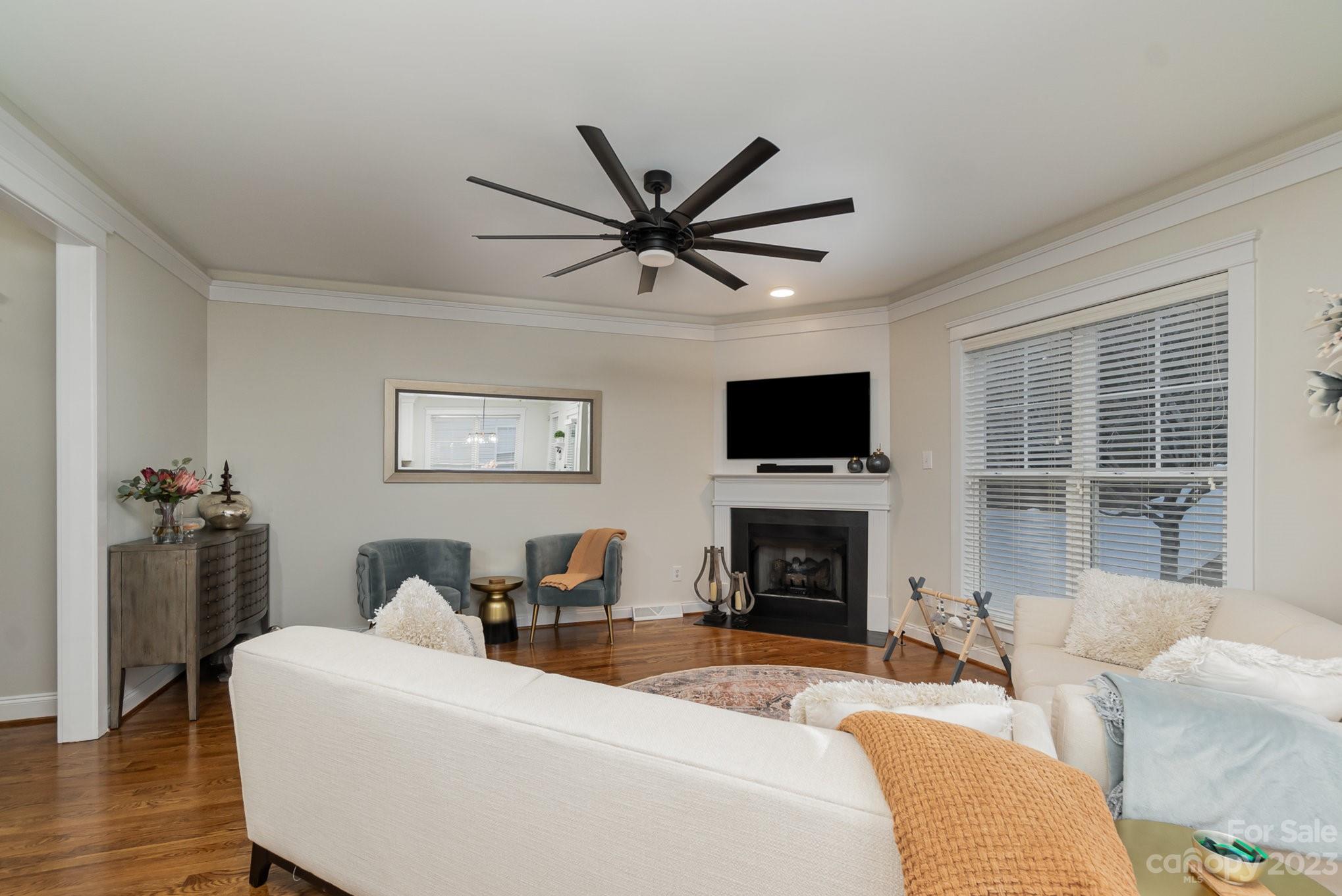 8128 Townley Road Huntersville, NC 28078 - Photo 5 of 20 a living room with furniture a fireplace and a flat screen tv