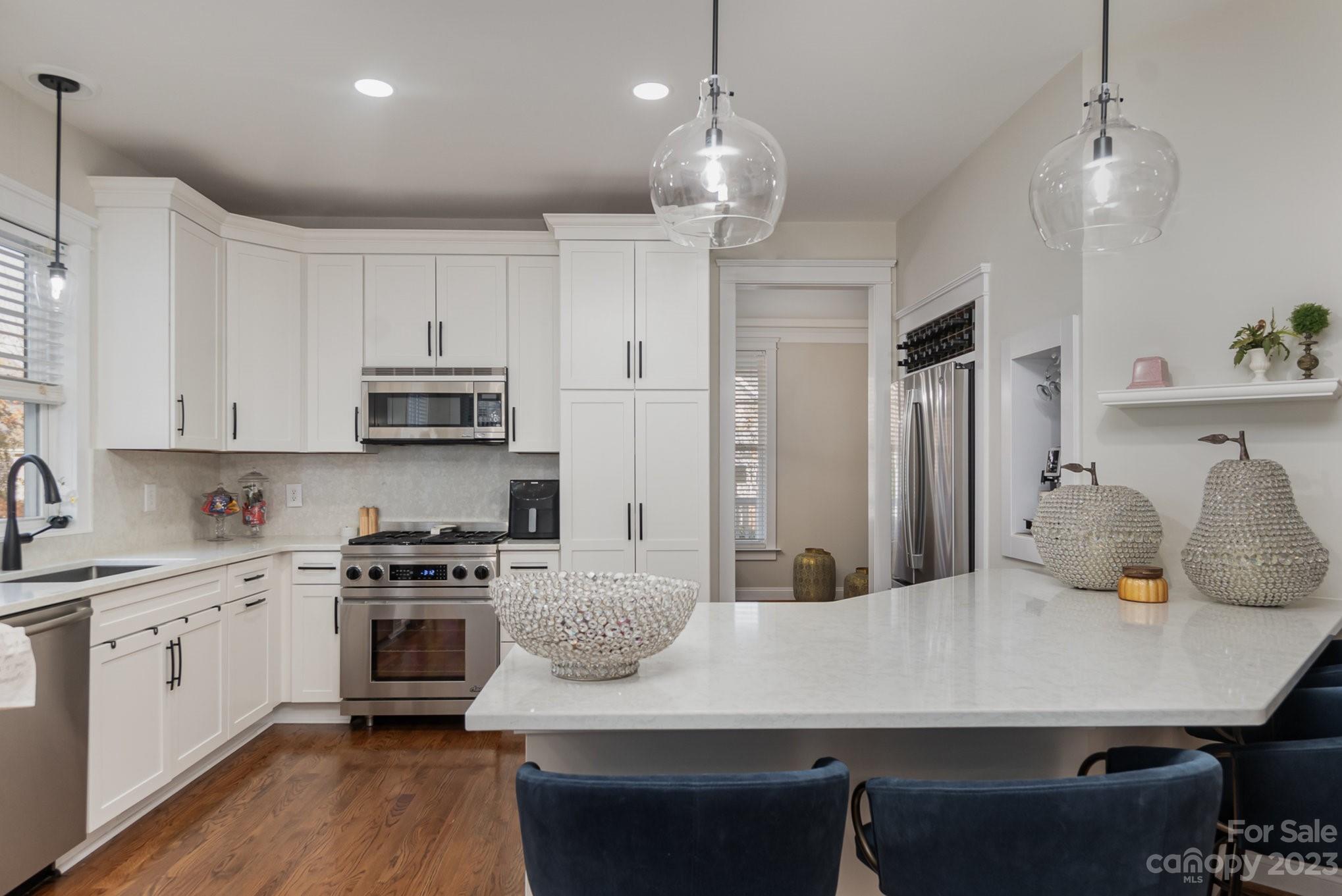 8128 Townley Road Huntersville, NC 28078 - Photo 7 of 20 a kitchen with stainless steel appliances granite countertop a sink a stove a refrigerator and island