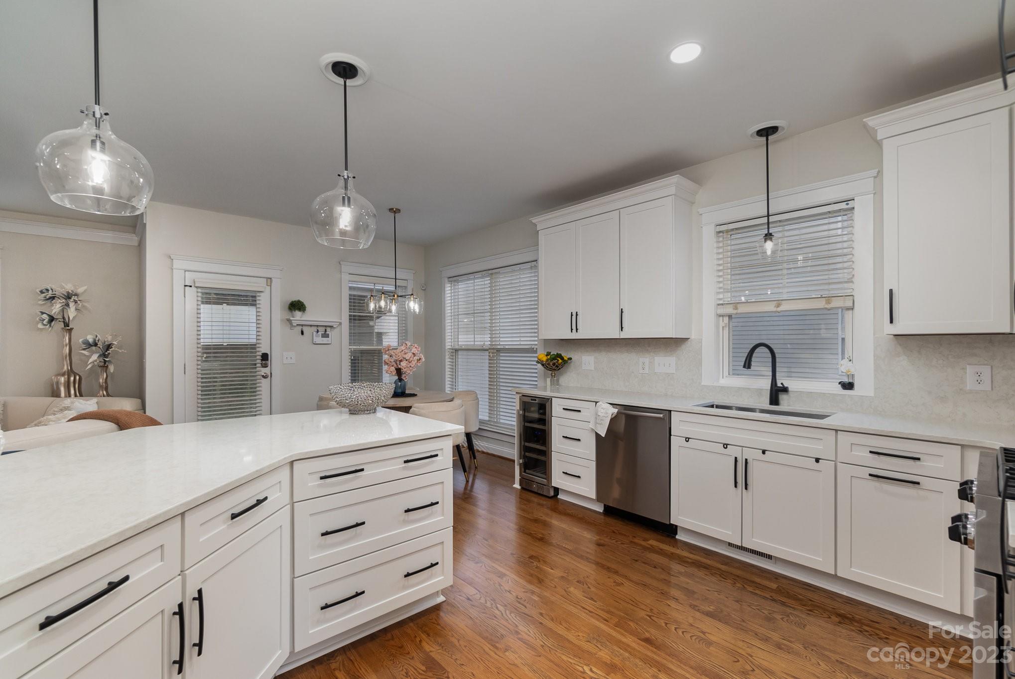 8128 Townley Road Huntersville, NC 28078 - Photo 9 of 20 a kitchen with kitchen island white cabinets and white appliances