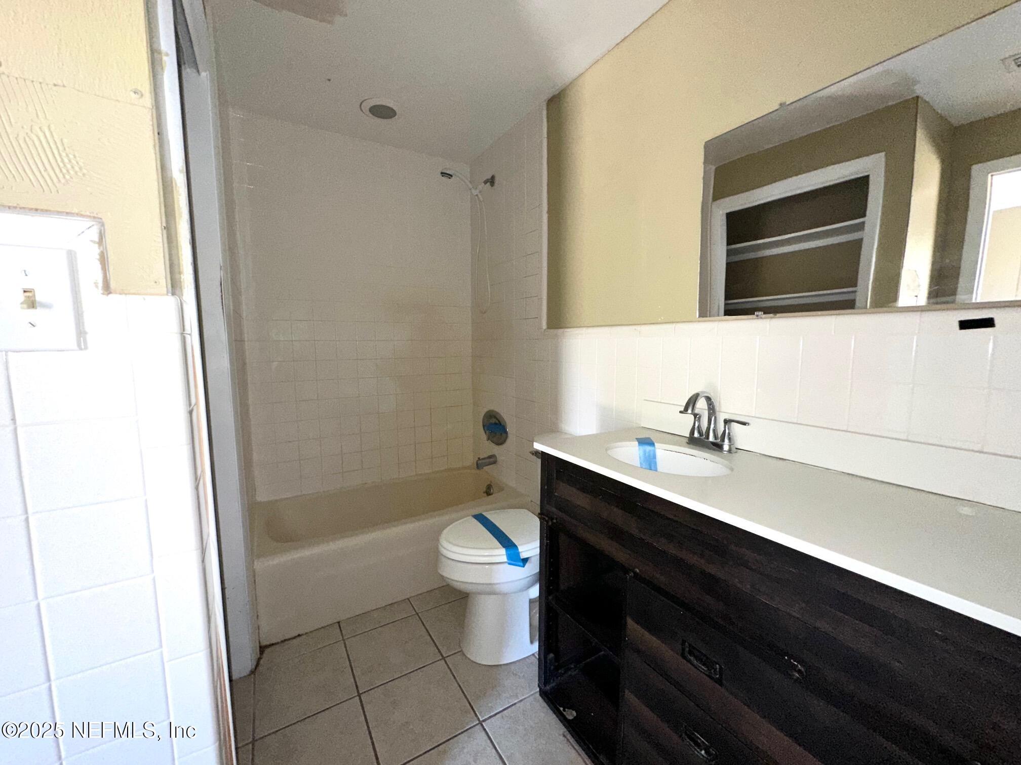 27734 Lake Jem Road Mount Dora, FL 32757 - Photo 15 of 19 a bathroom with a granite countertop toilet sink and mirror