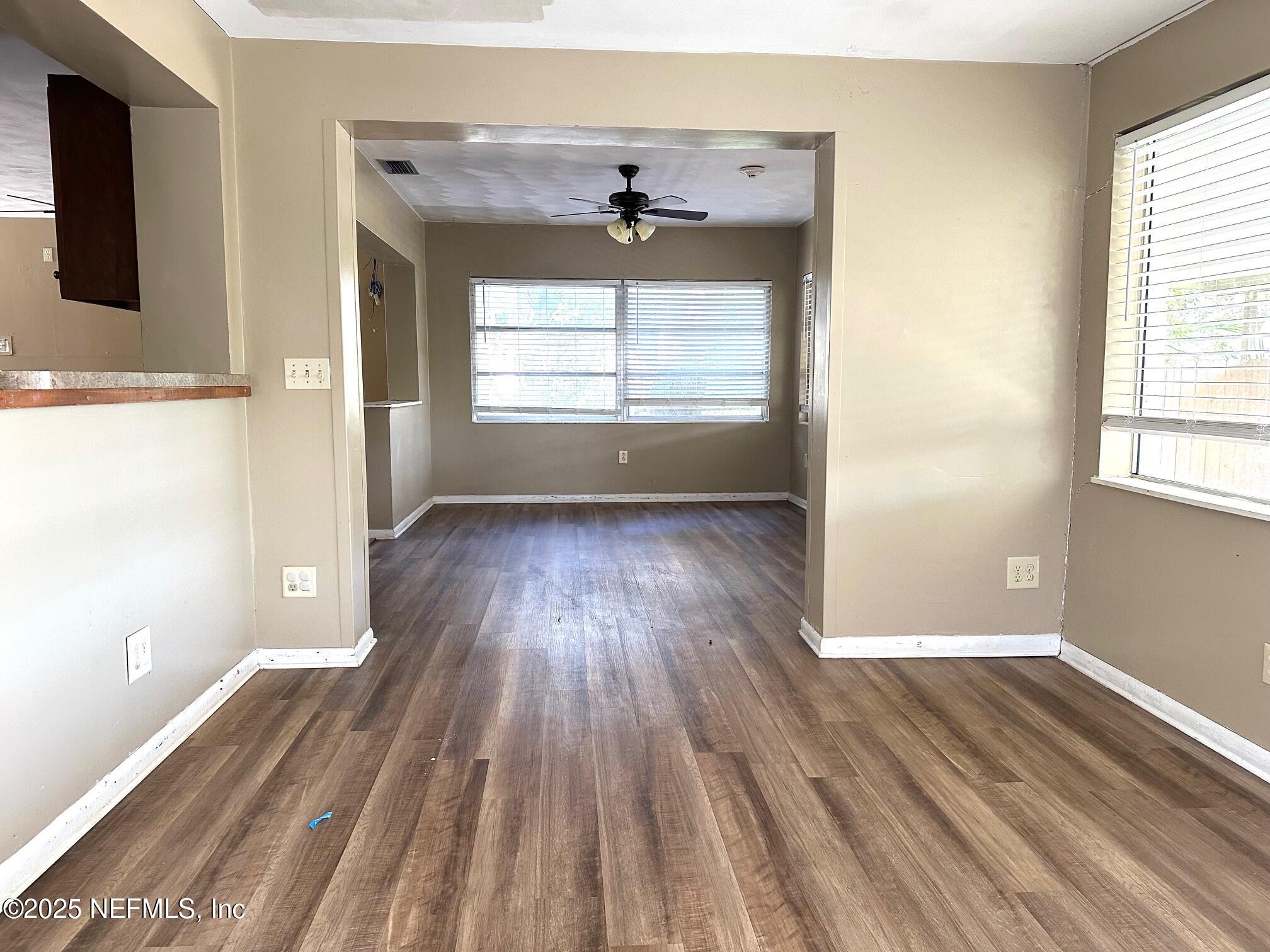 27734 Lake Jem Road Mount Dora, FL 32757 - Photo 8 of 19 wooden floor in an empty room with a window