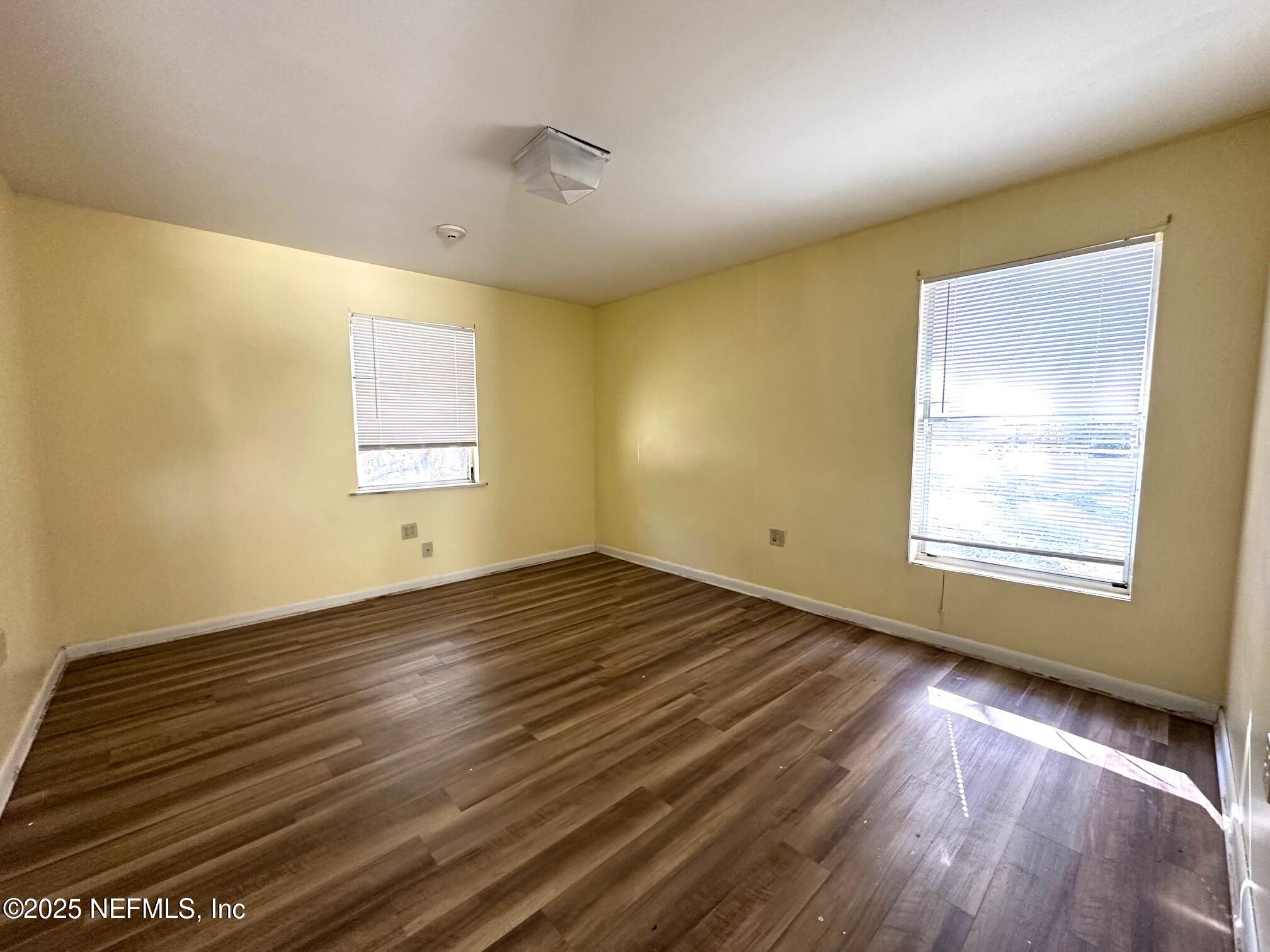 27734 Lake Jem Road Mount Dora, FL 32757 - Photo 9 of 19 a view of an empty room with wooden floor and a window