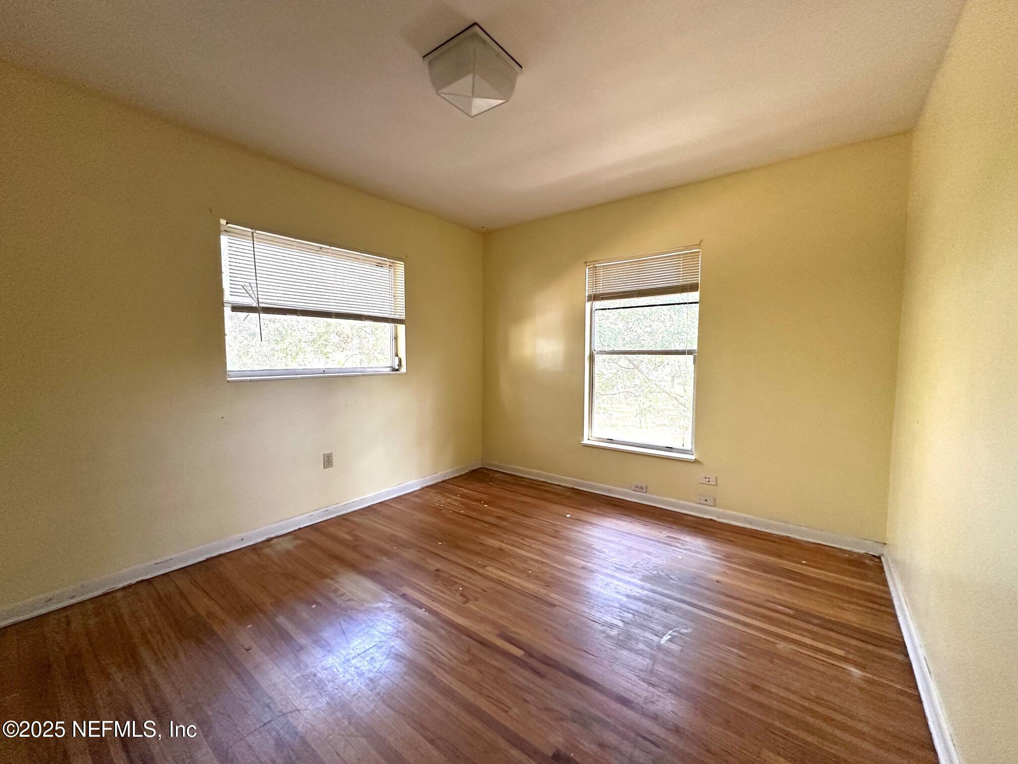 27734 Lake Jem Road Mount Dora, FL 32757 - Photo 10 of 19 a view of an empty room with wooden floor and a window