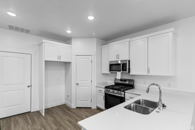 3014 South 265th Street West Logan, UT 84321 - Photo 8 of 25 Modern kitchen featuring white cabinetry, stainless steel appliances, a double basin sink, and ample countertop space