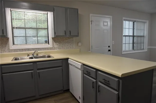 a kitchen with a sink cabinets and window