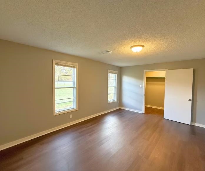 433 Dixie Road Memphis, TN 38109 - Photo 9 of 11 an empty room with wooden floor and windows