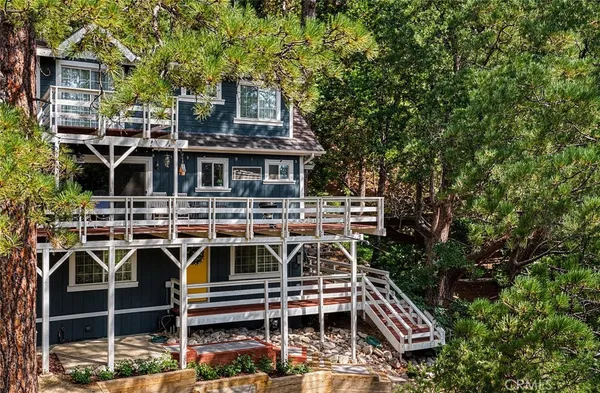 a front view of a house with a trees