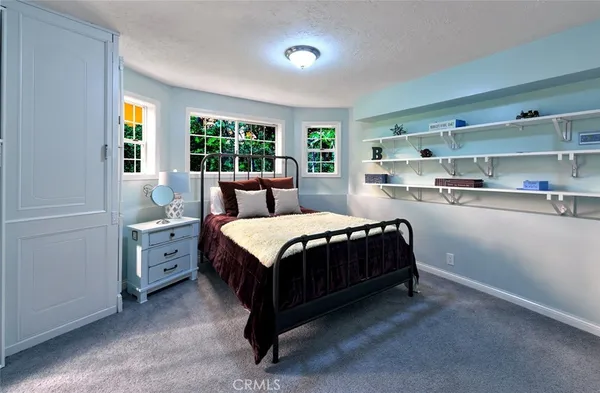 a spacious bedroom with a bed and a window