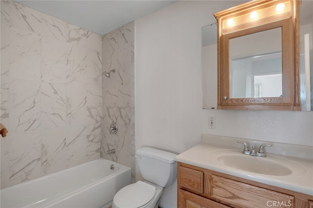 12736 Oasis Road Pinon Hills, CA 92372 - Photo 17 of 33 a bathroom with a sink toilet vanity and shower