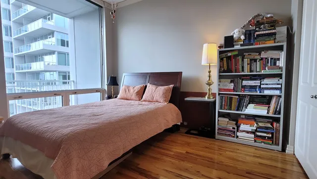 a bedroom with a bed and a book shelf