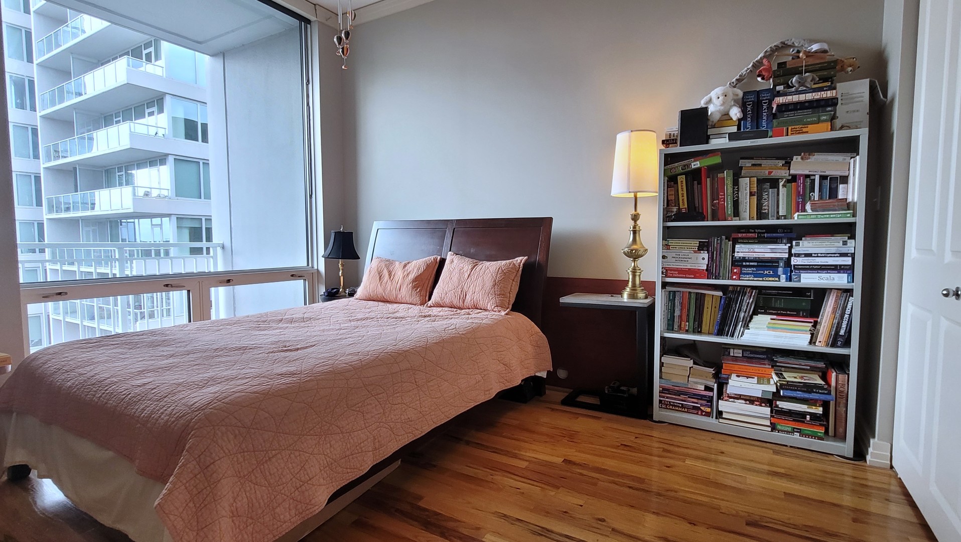 170 West Polk Street, Unit 1003 Chicago, IL 60605 - Photo 14 of 27 a bedroom with a bed and a book shelf