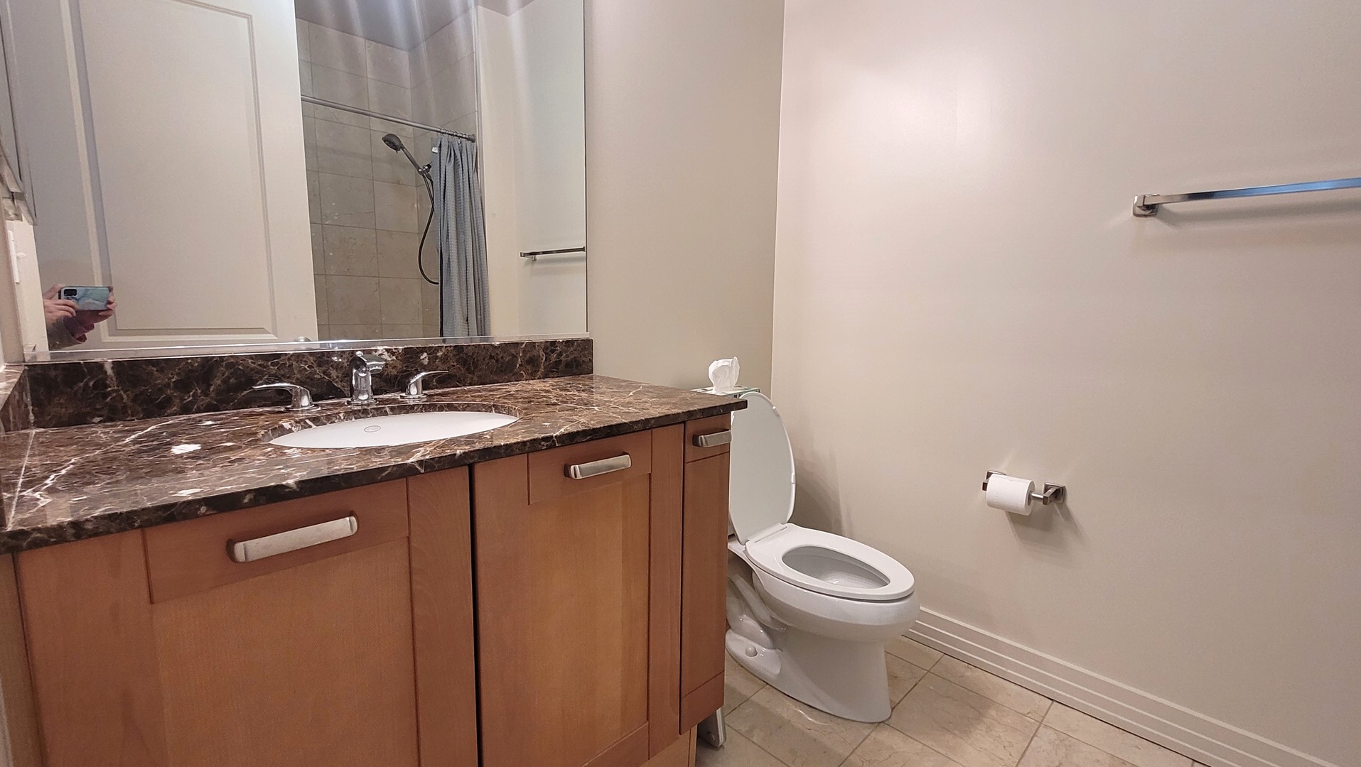 170 West Polk Street, Unit 1003 Chicago, IL 60605 - Photo 17 of 27 a bathroom with a granite countertop sink a toilet and a mirror