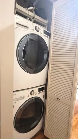 a view of a bedroom with wooden floor