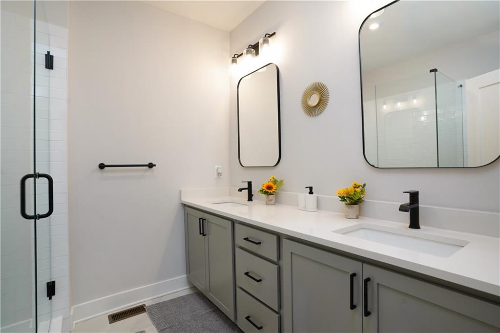 154 Chestnut Circle, Unit 80 Atlanta, GA 30342 - Photo 11 of 31 a bathroom with a sink and mirror