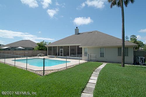 703 Cherry Street Neptune Beach, FL 32266 - Photo 14 of 15 a view of a house with swimming pool and a yard