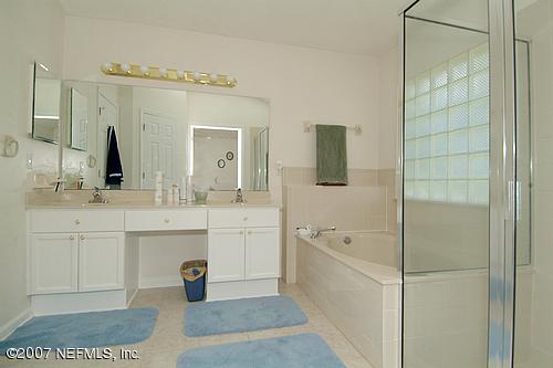 703 Cherry Street Neptune Beach, FL 32266 - Photo 8 of 15 a spacious bathroom with a tub sink and mirror