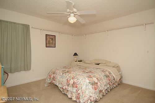 703 Cherry Street Neptune Beach, FL 32266 - Photo 9 of 15 a bedroom with a bed and a ceiling fan