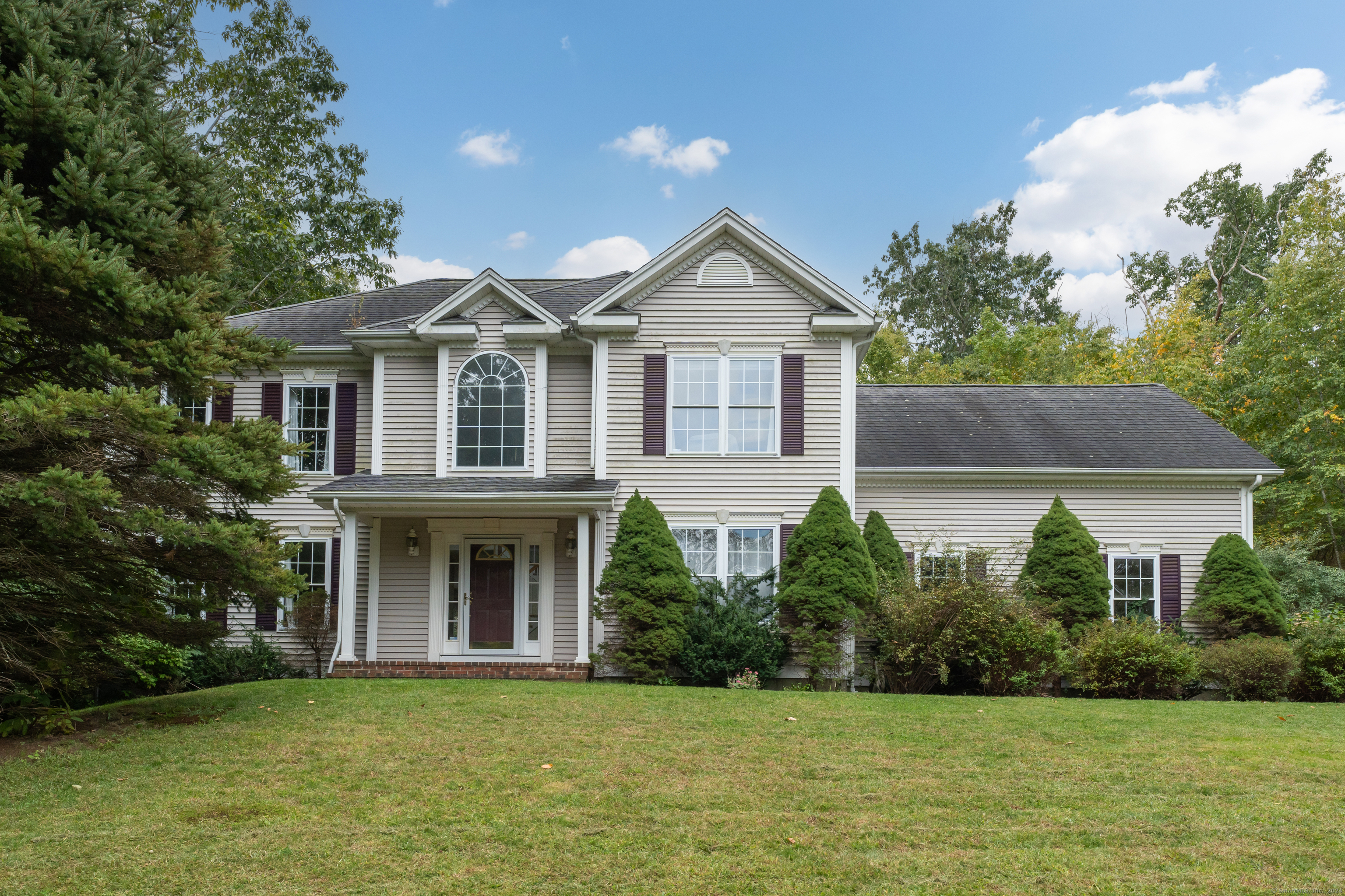 a front view of a house with garden