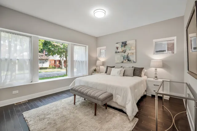 a spacious bedroom with a bed and a large window